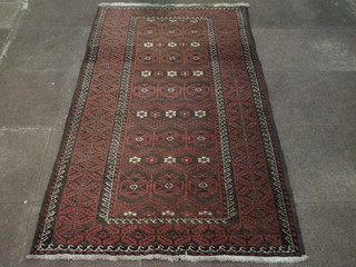 A red ground Belouch rug with central medallion and multi row  borders 83" x 44"