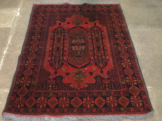 A red ground Persian carpet with stylised design to the centre within multi row borders 75" x 49"