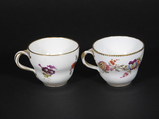 A pair of Continental porcelain cups with floral decoration