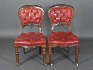 A handsome set of 6 Victorian carved mahogany dining chairs, the arched backs carved acorns and oak leaves, the seats and  backs upholstered in red buttoned leather, raised on turned and  fluted supports  ILLUSTRATED