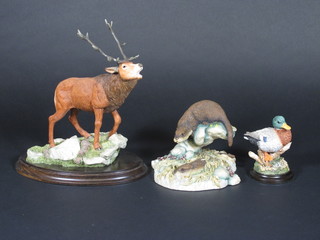A pottery figure of a Stag, a Teviotdale figure of an otter and a Country Arts figure of a duck