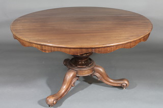A Victorian circular mahogany snap top breakfast table, raised on  a turned column and tripod base 50"