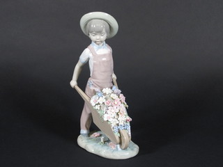 A Lladro figure of a standing boy with wheel barrow of flowers  10"