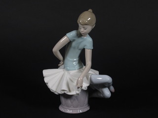 A Lladro figure of a seated ballerina 9"