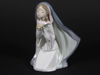 A Lladro figure of a kneeling nun, base incised 5792 7"
