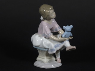 A Lladro figure of a seated girl with teddybear 6 1/2"
