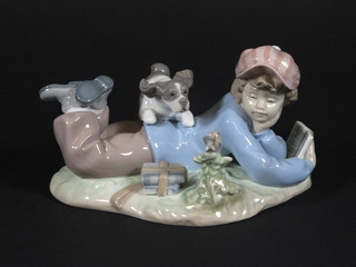 A Lladro figure of a reclining boy with dog and bird, base  marked 5451 7"
