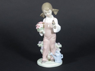 A Lladro figure of a girl with bird, base marked 5217 7"