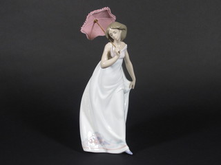 A Lladro figure of a lady with parasol, base marked 7636 10"