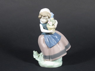 A Lladro figure of a girl with pot plant, base marked 5223 7"