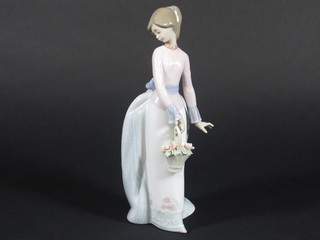 A Lladro figure of a lady with basket of flowers, base marked 7622 10"