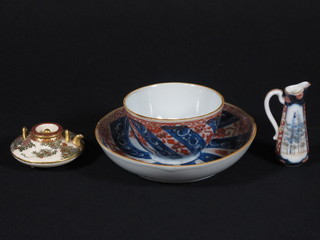 A Japanese Imari teabowl and saucer, an Imari jug 2" and a  circular Japanese Satsuma miniature teapot 2", base with seal  mark