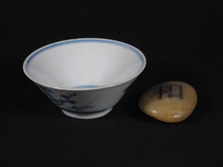 An Oriental blue and white rice bowl 4" and a carved pebble  scholar's weight