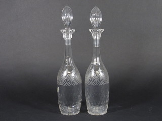 A pair of etched glass club shaped decanters and stoppers