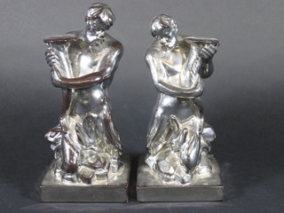 A pair of silver glazed classical figures of seated gods with cornucopias 9"