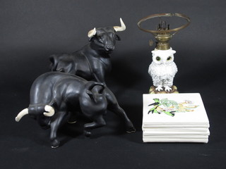 A pair of black glazed pottery figures of bulls 14", a Victorian  blanc de chine porcelain oil lamp base in the form of an owl 7",  7 tiles decorated birds
