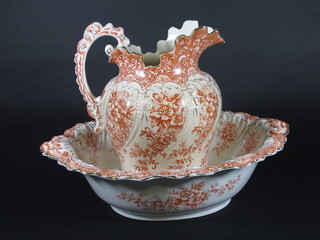 An orange and floral patterned Colesberg jug and bowl set,  cracked,