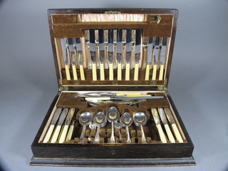 A canteen of Old English pattern silver plated flatware contained  in a walnut canteen box
