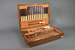 A canteen of silver plated flatware by the Goldsmiths and Silversmiths Co., contained in a walnut canteen