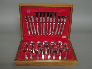 A canteen of chromium plated flatware contained in an oak canteen box