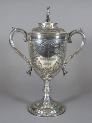 A Victorian embossed silver twin handled trophy cup the lid decorated a greyhound, marked Thomas Glover & Co Limited  Challenge Cup 400 yards 1897