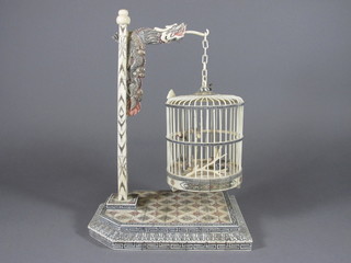 A carved Oriental ivory model of a bird cage, the interior  decorated birds, raised on a stand 15"