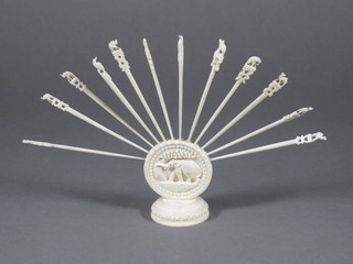 A set of 12 carved ivory cocktail sticks decorated animals