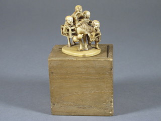 A carved ivory figure of a figure with horse and panier, base  with seal mark 2"