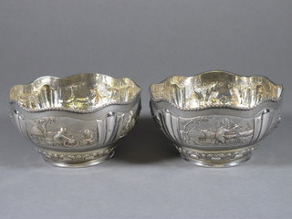 A pair of circular embossed Eastern white metal bowls 5"