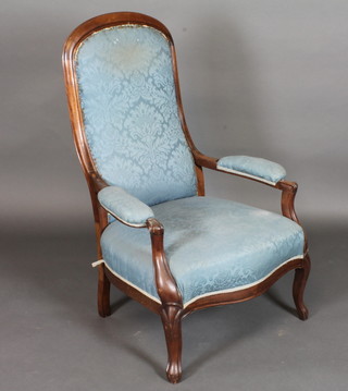 A Victorian mahogany open arm chair raised on cabriole supports
