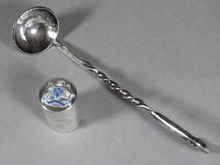 A cylindrical white metal and enamelled vesta case decorated the arms of Australia and a silver ladle formed from a coin