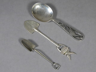 A silver caddy spoon decorated a stork, Chester 1948 and 2 white metal butter spoons in the form of spades