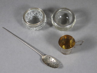 An antique silver mote spoon, 2 glass mounted salts and a white  metal measure