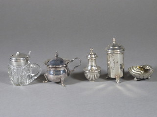 A silver mustard pot, a glass mustard pot with silver mount, 2 pepperettes and a scallop shaped salt