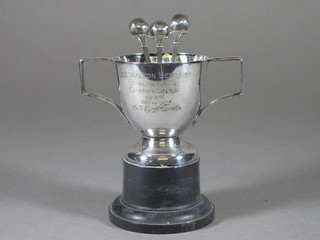 A silver plated twin handled bowling trophy and 3 silver plated teaspoons decorated bowling woods