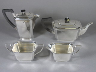 An Art Deco lozenge shaped silver plated 4 piece tea service with teapot, twin handled sugar bowl, milk jug and hotwater jug