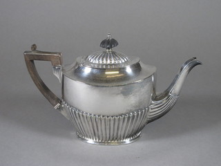 An oval Britannia metal teapot with demi-reeded decoration