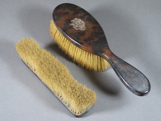 A tortoiseshell and gold mounted hairbrush together with a tortoiseshell mounted clothes brush