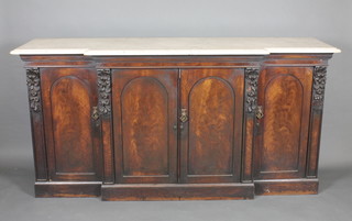 A Victorian mahogany break front sideboard with white veined marble top, the base fitted triple cupboards enclosed by panelled  doors raised on a platform base 73"  ILLUSTRATED