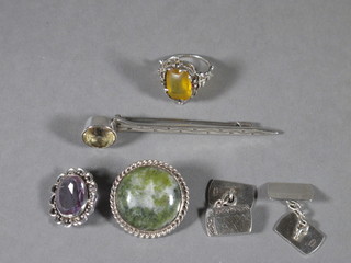 A silver brooch set a hardstone, a pair of silver cufflinks, 2 brooches and a ring