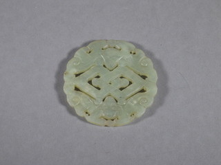 A circular pierced jade coloured pendant 2"