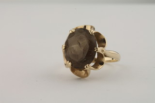 A 9ct gold dress ring set an oval topaz