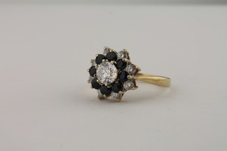 A gold dress ring set sapphires and white stones