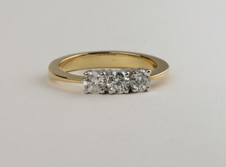 A lady's 18ct yellow gold dress ring set 3 diamonds, approx  0.55ct