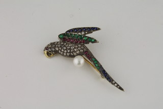 A gold brooch in the form of a parrot set rubies, diamonds, emeralds and sapphires