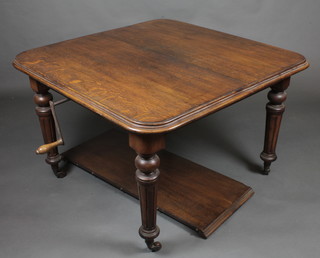 A Victorian oak extending dining table raised on turned and fluted supports with 1 extra leaf 43"