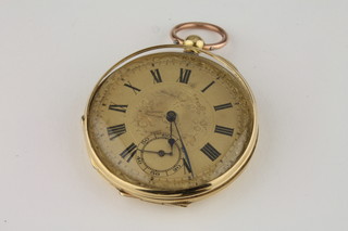 An open faced fob watch contained in a gilt case