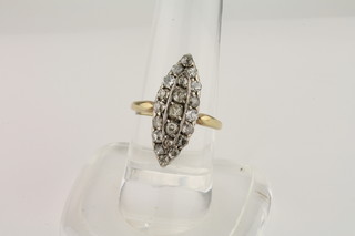 A gold marquise shaped dress ring set diamonds