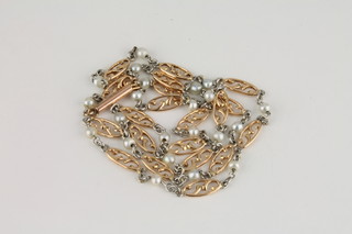 A platinum and gold necklet set pearls