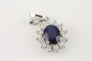 A lady's 18ct white gold pendant set sapphires and diamonds